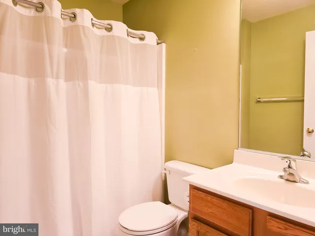 an empty room with a chandelier fan