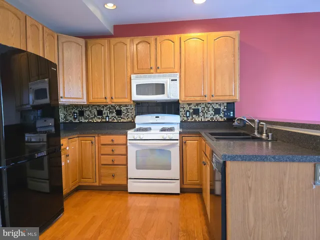 a view of a kitchen cabinets and a stove top oven