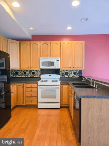 a kitchen with granite countertop a stove and a sink