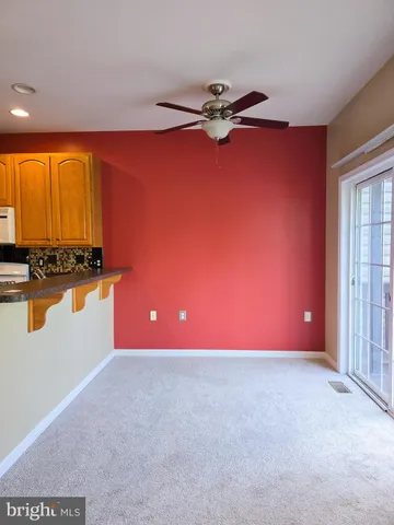 a kitchen with granite countertop a sink stove and cabinets