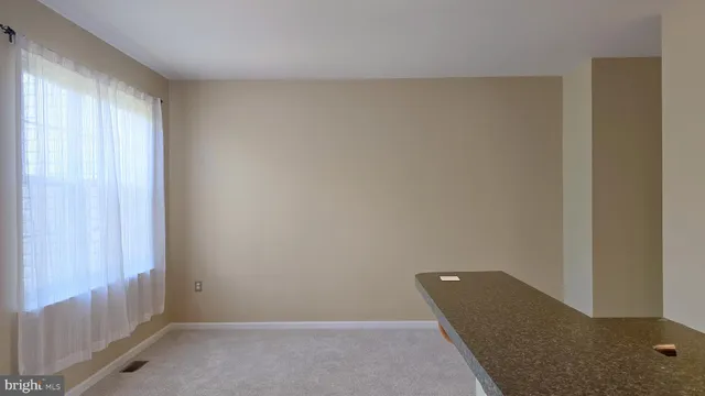 a view of an empty room and a window