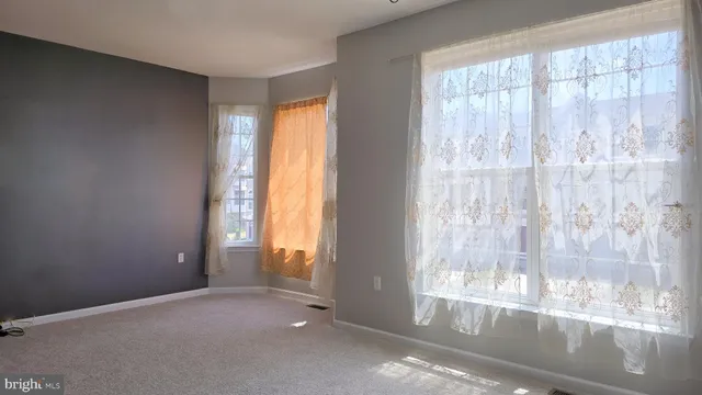 a view of a hallway with wooden floor and door