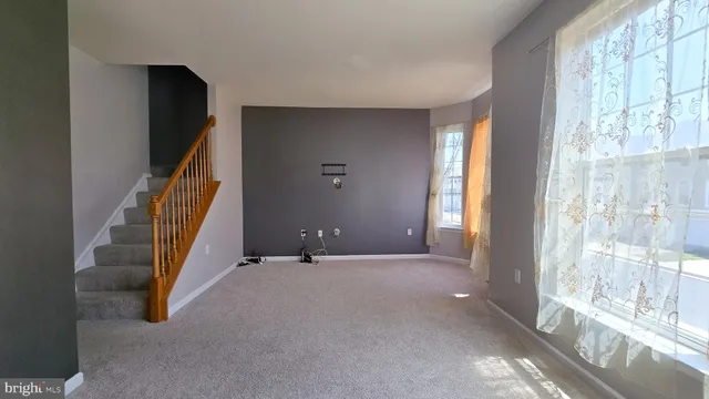 a room with gym equipment and large windows