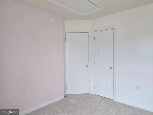 a view of a big room with closet and a chandelier fan
