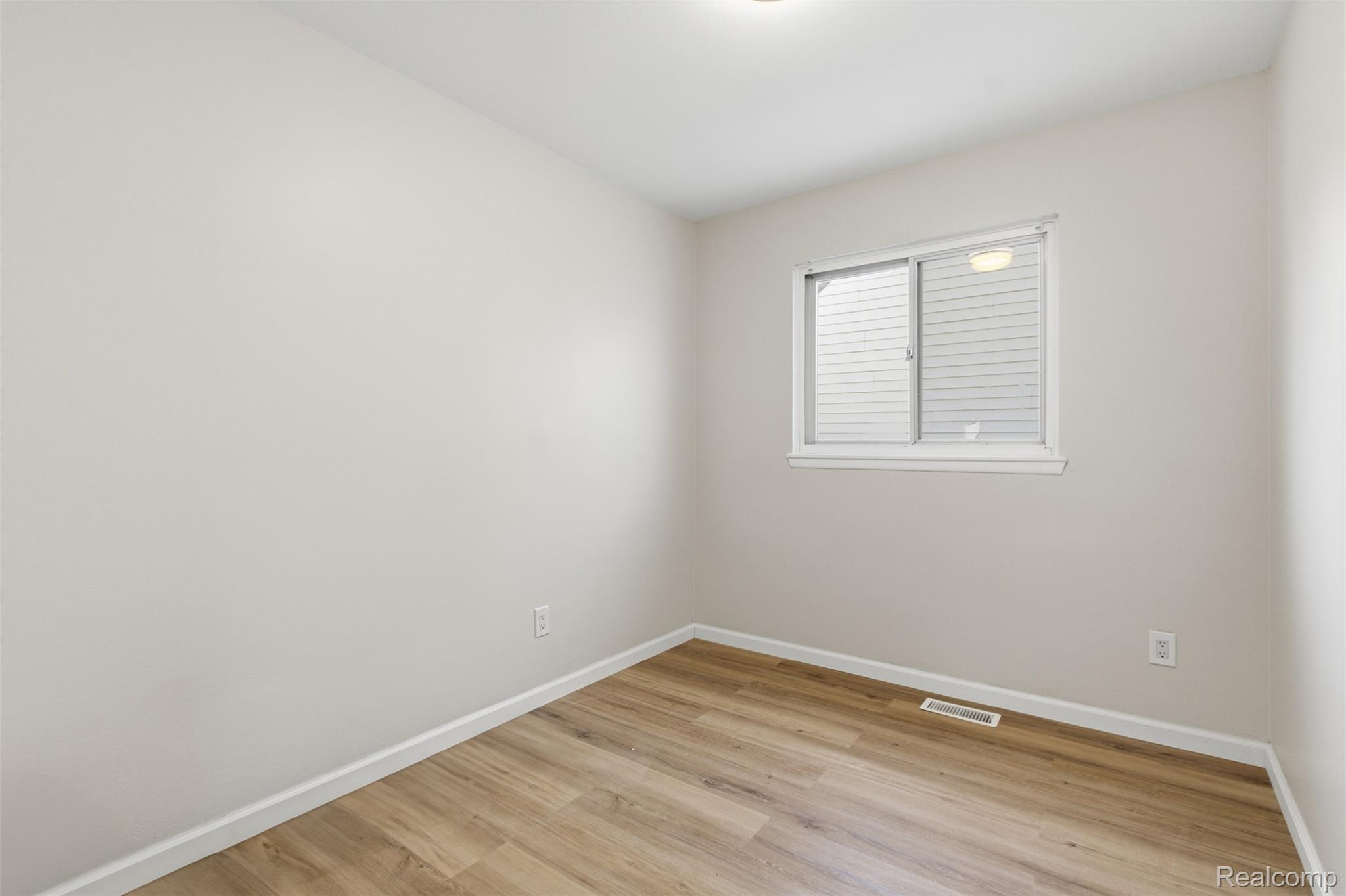 14731 Stephens Road Eastpointe, MI 48021 - Photo 10 of 15 Empty room featuring light wood-style flooring and baseboards