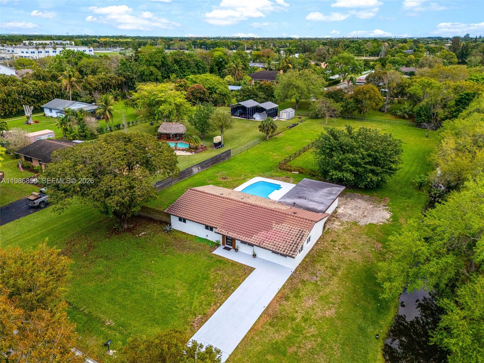 an aerial view of a house with a yard