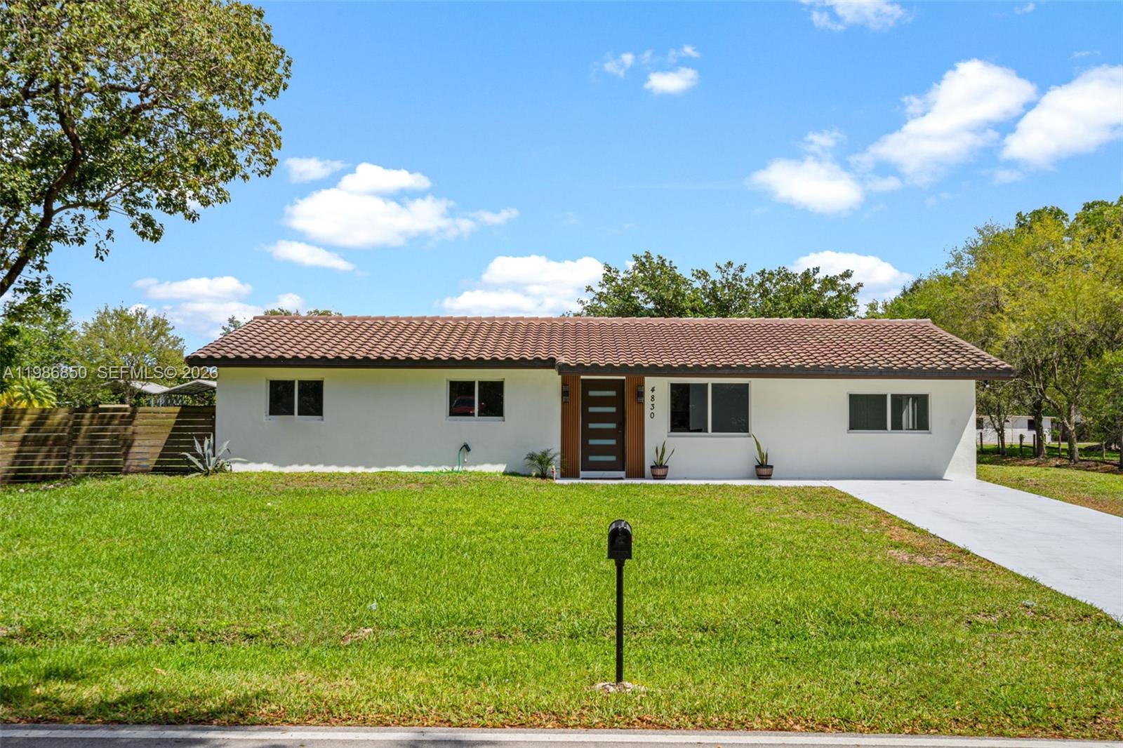 4830 Southwest 188th Avenue Southwest Ranches, FL 33332 - Photo 12 of 58 a view of a house with a yard and potted plants