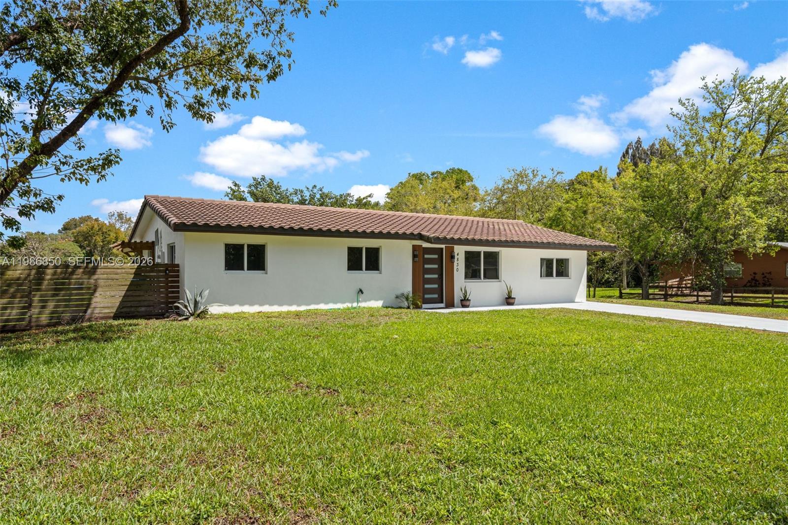 4830 Southwest 188th Avenue Southwest Ranches, FL 33332 - Photo 13 of 58 a front view of house with yard and green space