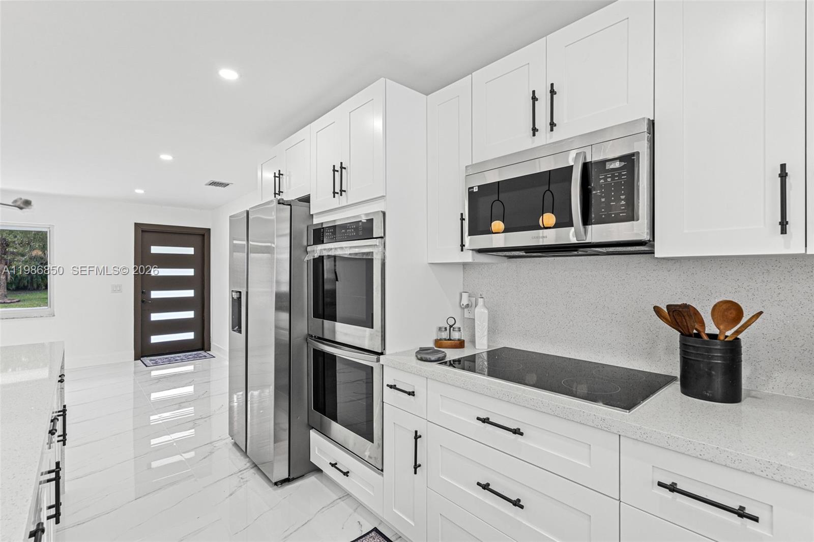 4830 Southwest 188th Avenue Southwest Ranches, FL 33332 - Photo 23 of 58 a kitchen with stainless steel appliances granite countertop a refrigerator and a stove top oven