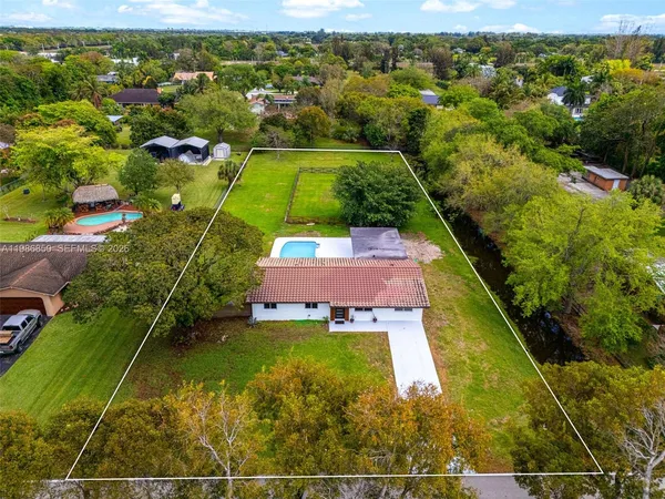 an aerial view of residential houses with outdoor space and street view