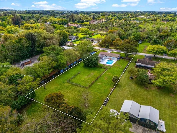 a view of a house with a yard and potted plants