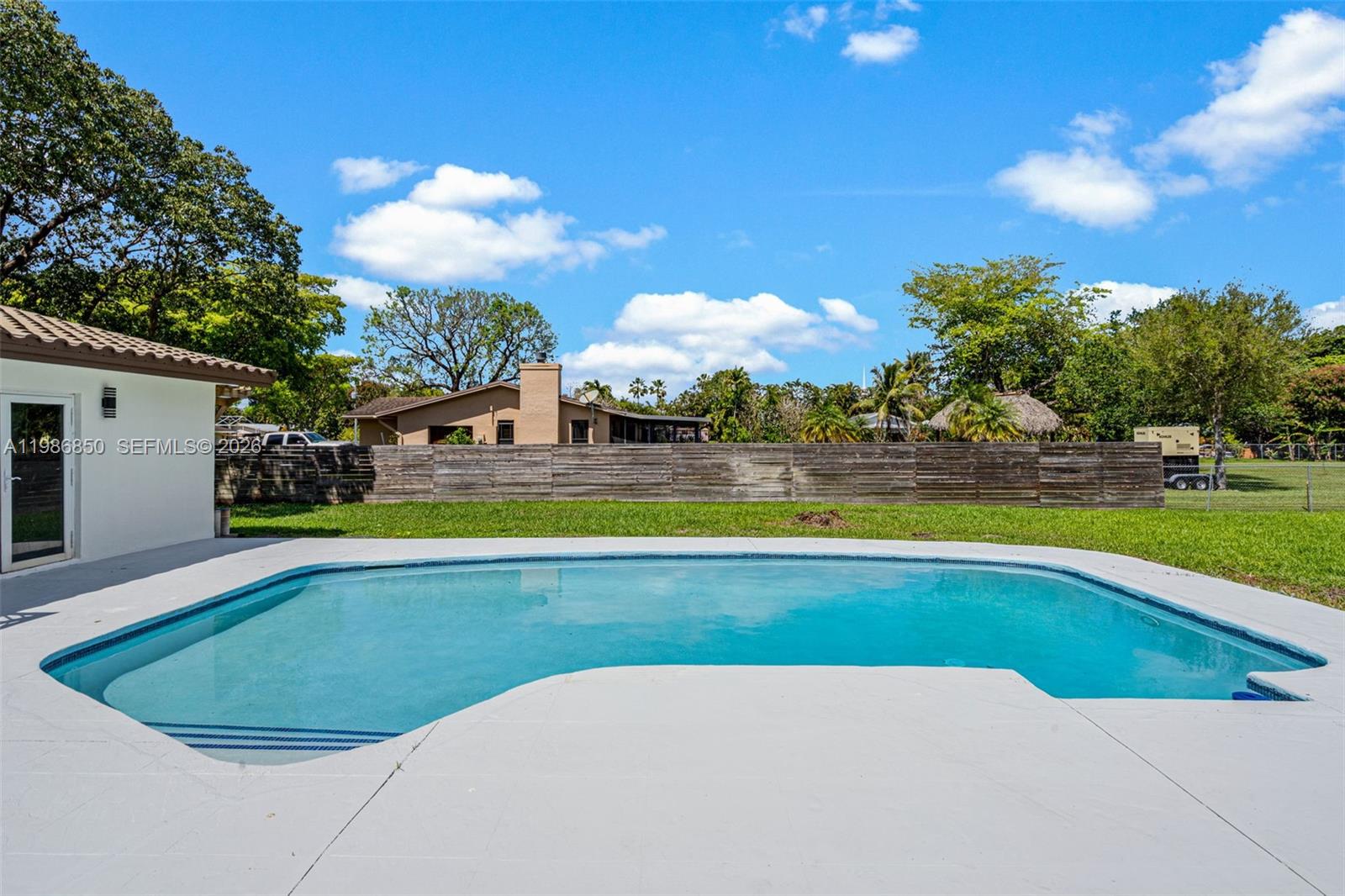 4830 Southwest 188th Avenue Southwest Ranches, FL 33332 - Photo 53 of 58 a view of a swimming pool with an outdoor space and seating area