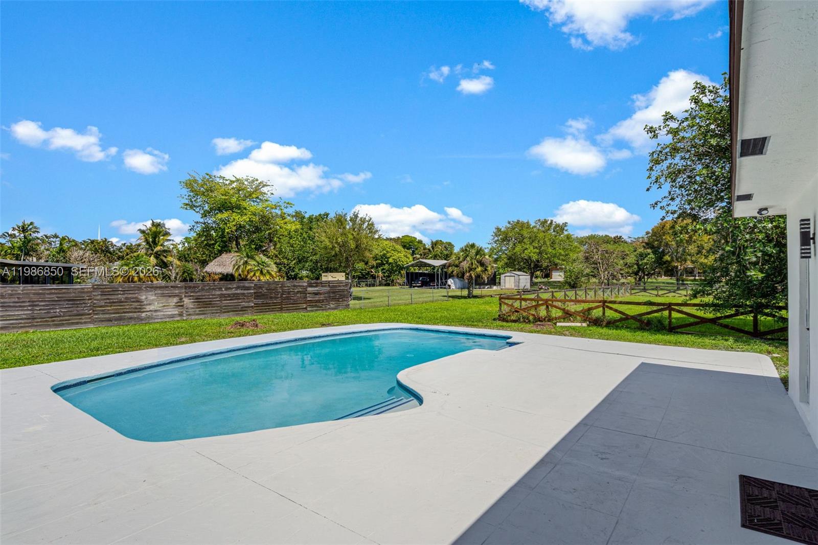 4830 Southwest 188th Avenue Southwest Ranches, FL 33332 - Photo 54 of 58 a view of a swimming pool and a yard