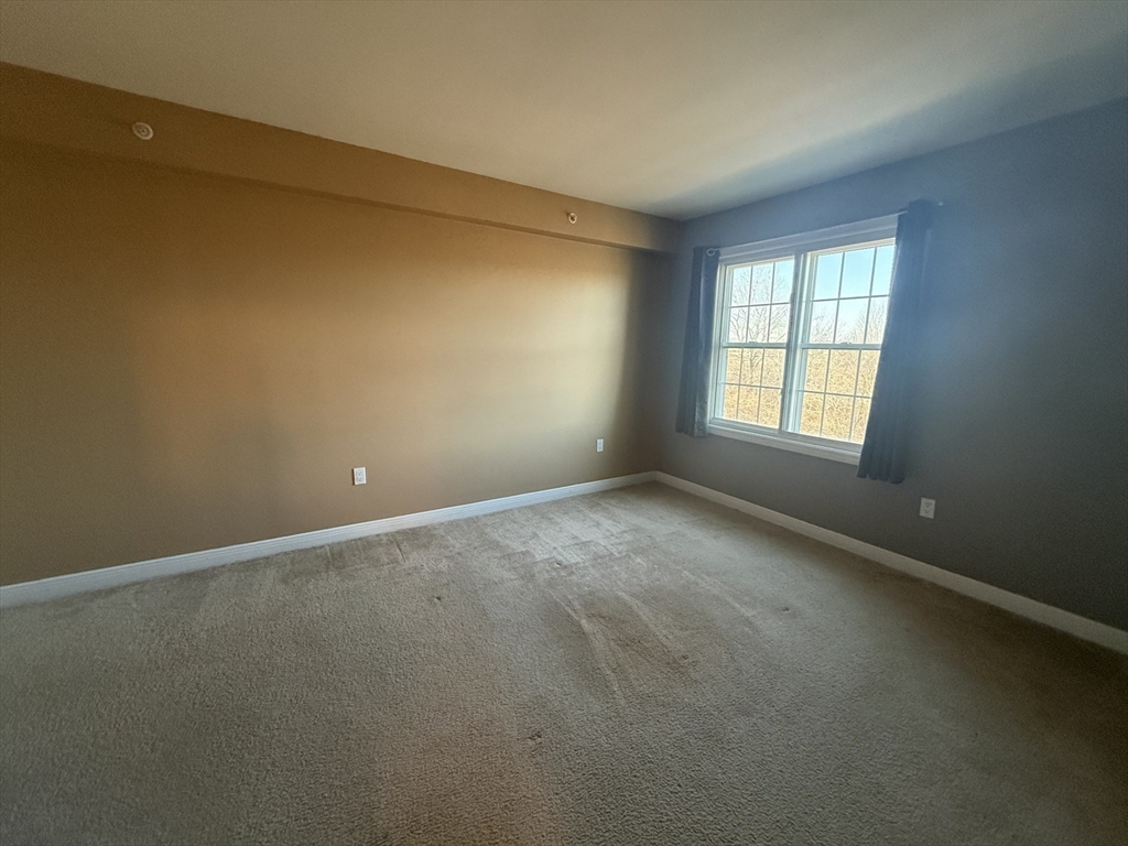 145 Bennington Street, Unit 307 Revere, MA 02151 - Photo 4 of 7 an empty room with a window
