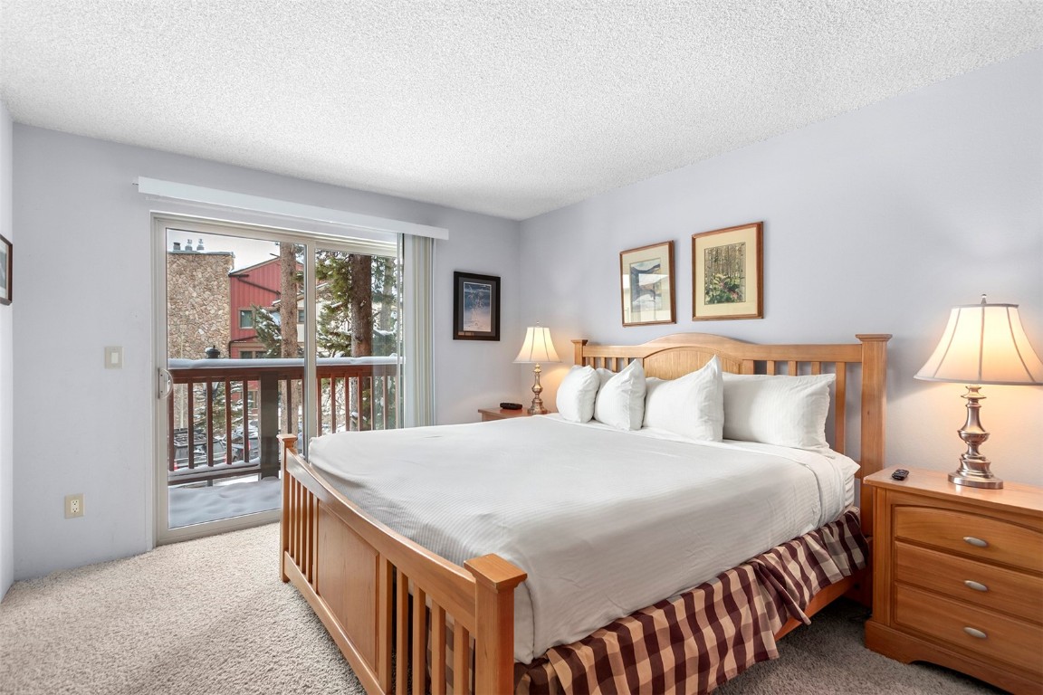 405 4 O Clock Road, Unit 12B Breckenridge, CO 80424 - Photo 15 of 27 a bedroom with a large bed and a window