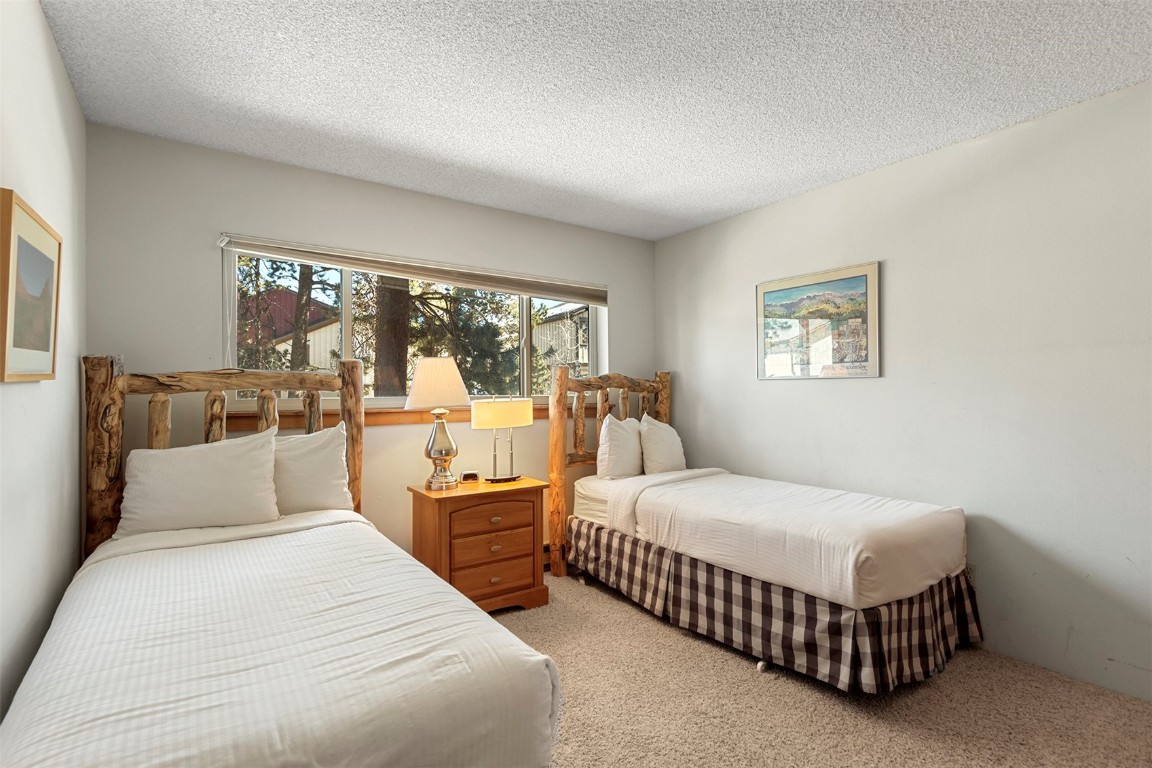 405 4 O Clock Road, Unit 12B Breckenridge, CO 80424 - Photo 16 of 27 a bedroom with a bed and a large window