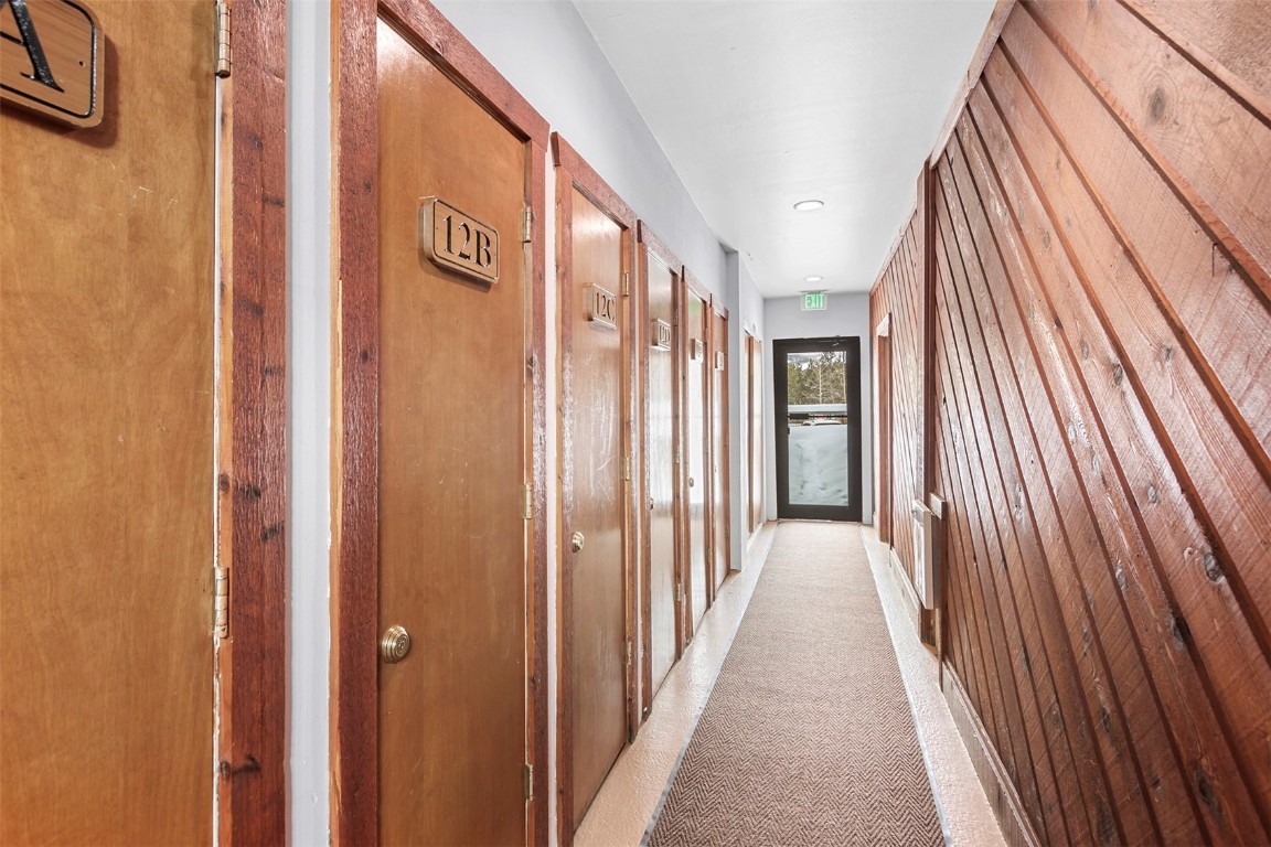 405 4 O Clock Road, Unit 12B Breckenridge, CO 80424 - Photo 20 of 27 a view of a hallway with wooden floor and staircase