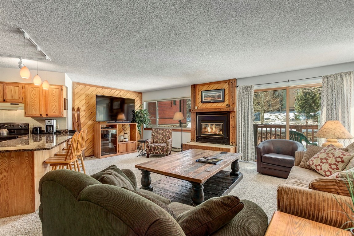 405 4 O Clock Road, Unit 12B Breckenridge, CO 80424 - Photo 3 of 27 a living room with furniture fireplace and a large window