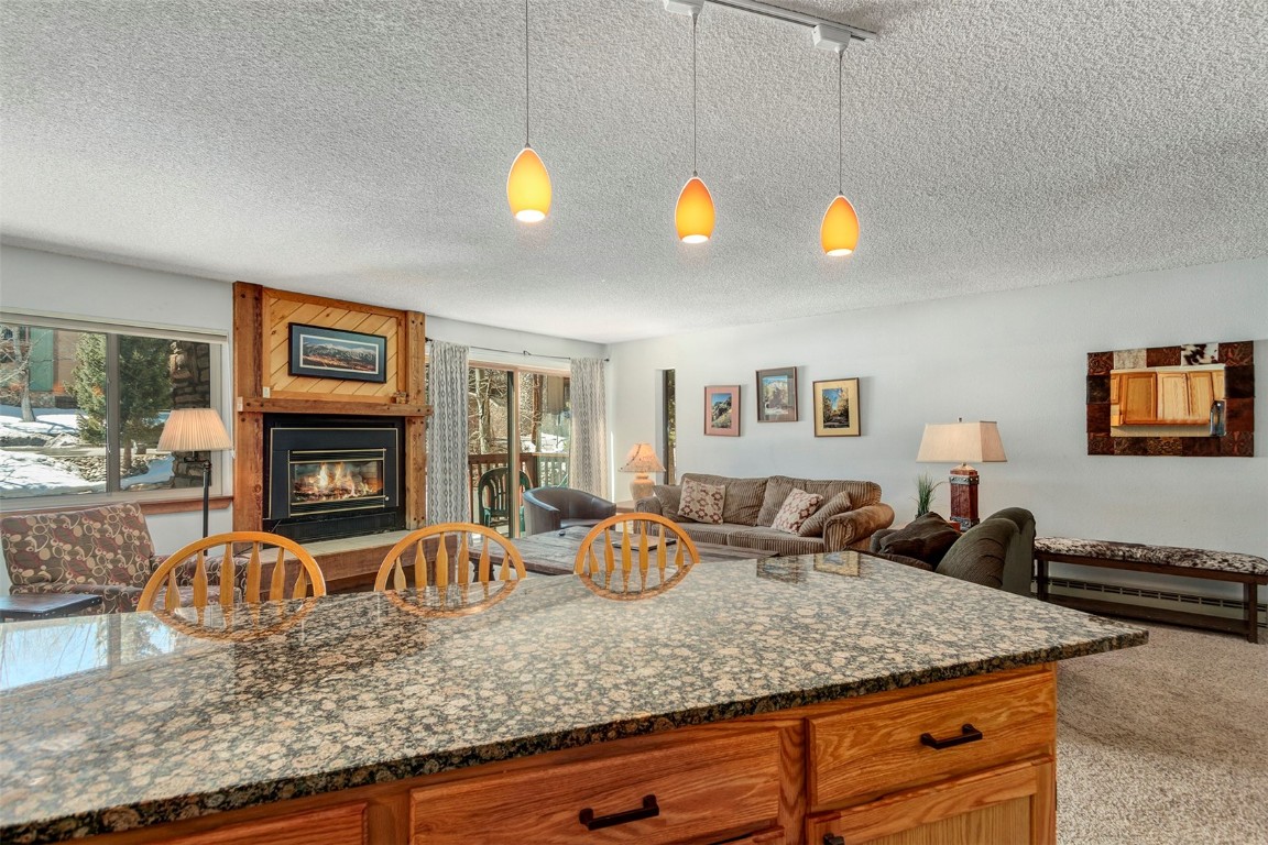 405 4 O Clock Road, Unit 12B Breckenridge, CO 80424 - Photo 10 of 27 a living room with granite countertop furniture and fireplace