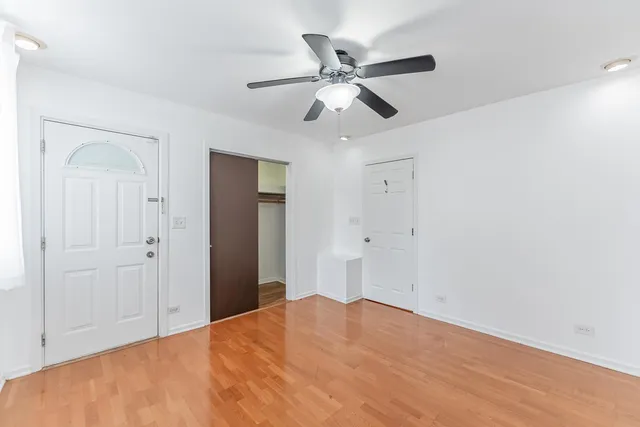 a view of a room with a ceiling fan