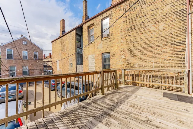 a view of a balcony with wooden floor