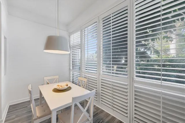 a view of a room that has a table and chairs in it