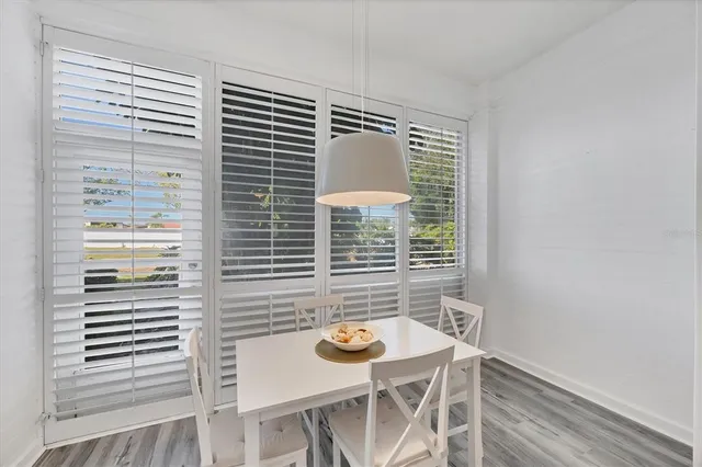 a view of a dining room with furniture and window