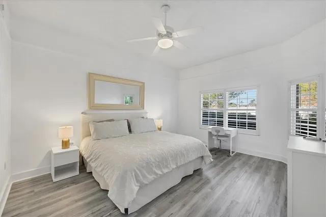 a bedroom with a large bed and a window