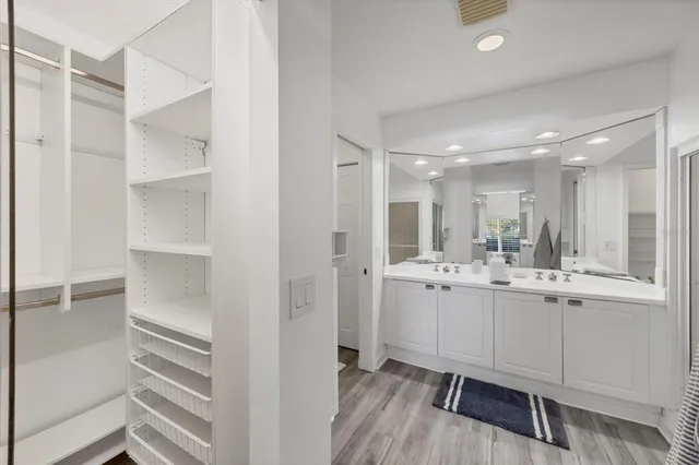 a bathroom with a double vanity sink a mirror and a shower