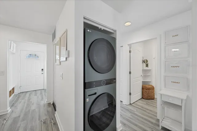 a view of a hallway with closet and wooden floor