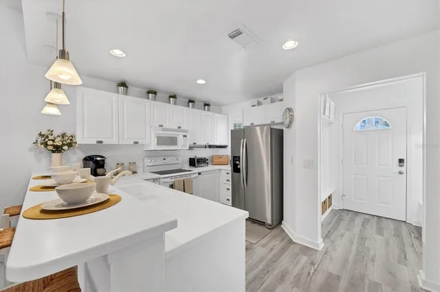 a kitchen with refrigerator and cabinets
