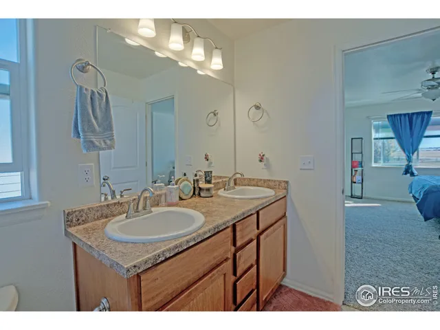 a bathroom with a sink double vanity and a mirror