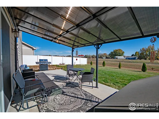 a view of a backyard with sitting area