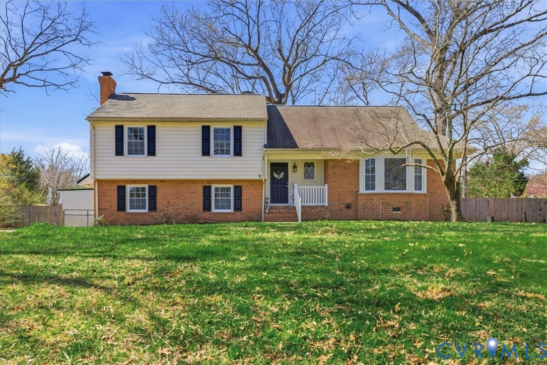 11719 Heathmere Crescent Midlothian, VA 23113 - Photo 1 of 31 a view of a yard in front of a brick house with large windows