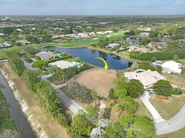 an aerial view of a houses with a lake view