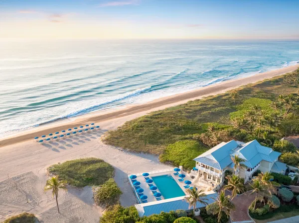 an aerial view of residential houses with outdoor space and lake view