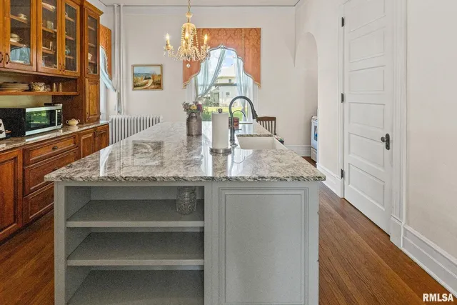 a bathroom with a sink a toilet a mirror and shower