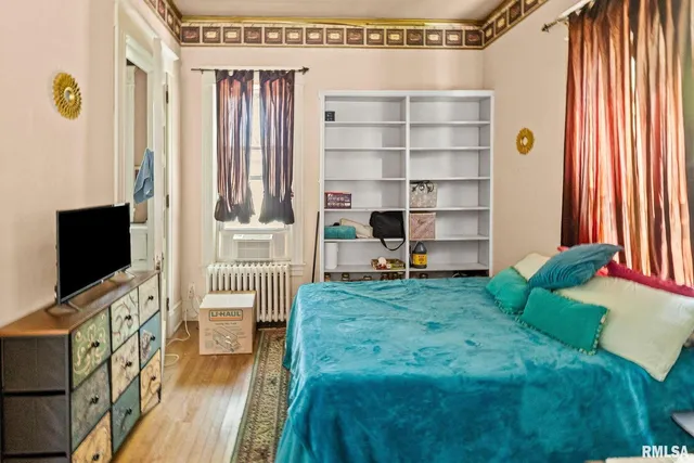 a bedroom with a bed and a window