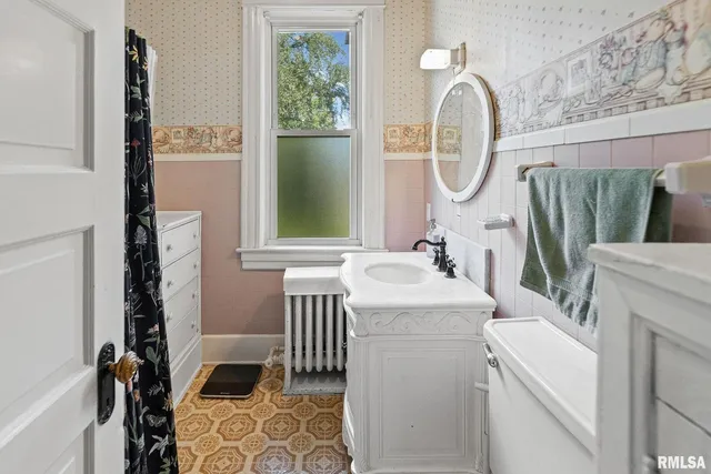 a bathroom with a sink a mirror and a bathtub