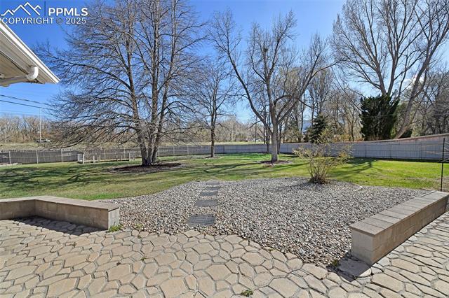 2421 Strickler Road Colorado Springs, CO 80906 - Photo 41 of 44 View of yard featuring a patio and a fenced backyard