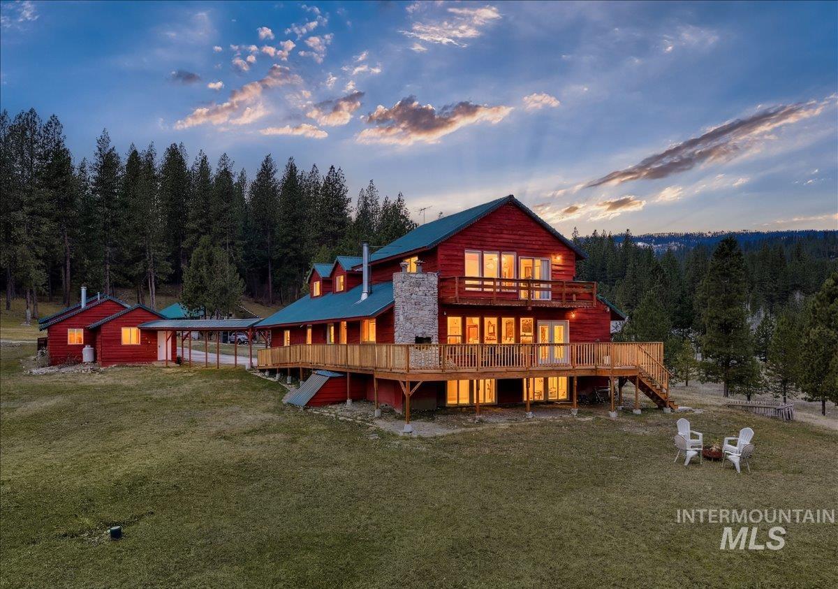 6 East Beck Road Garden Valley, ID 83622 - Photo 1 of 44 Back of property at dusk featuring a deck and a lawn