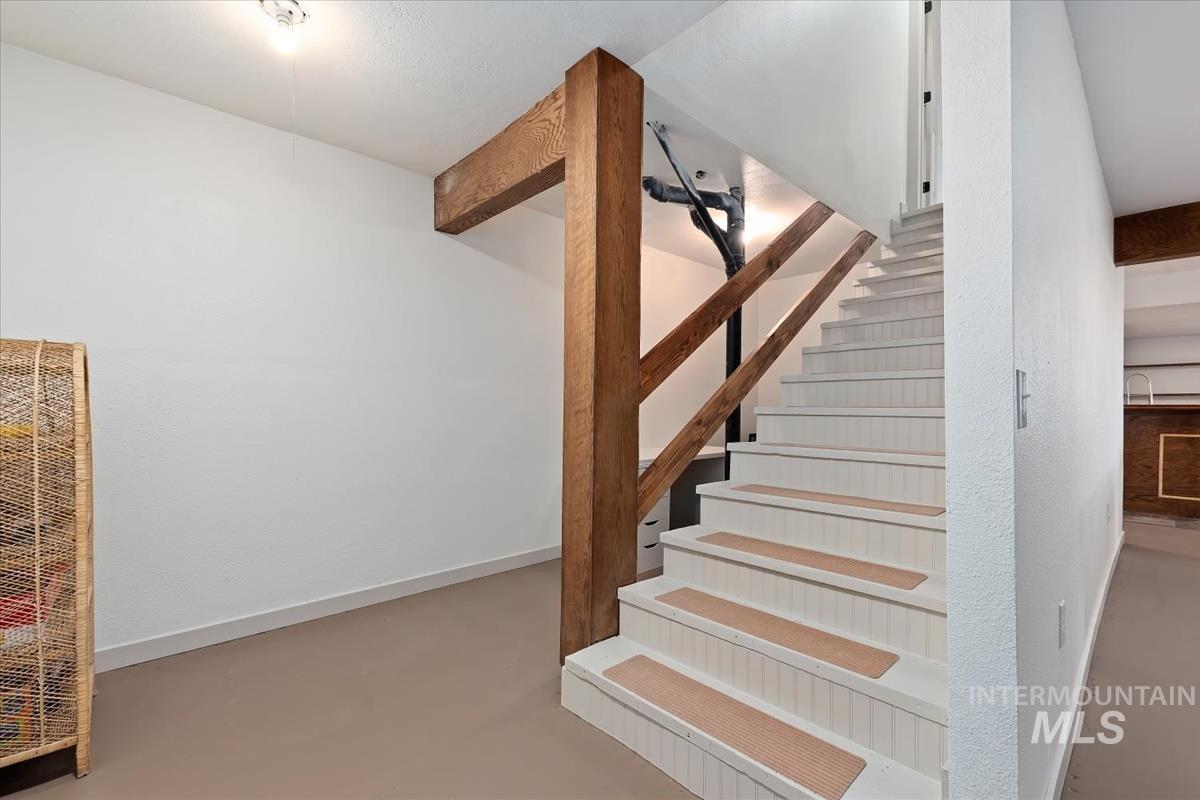 6 East Beck Road Garden Valley, ID 83622 - Photo 26 of 44 Stairway featuring a heating unit and concrete floors
