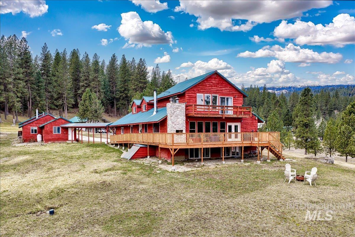 6 East Beck Road Garden Valley, ID 83622 - Photo 44 of 44 Back of property featuring a deck, a yard, and a metal roof