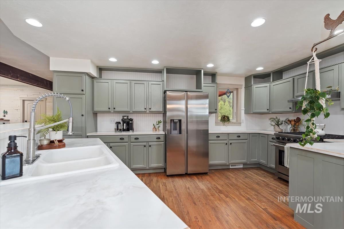 6 East Beck Road Garden Valley, ID 83622 - Photo 7 of 44 Kitchen featuring stainless steel fridge, light wood-type flooring, open shelves, recessed lighting, and gray cabinets