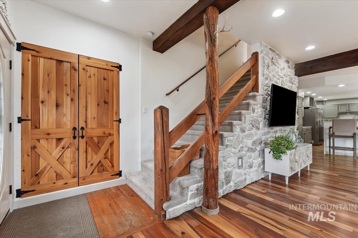6 East Beck Road Garden Valley, ID 83622 - Photo 8 of 44 Stairs with beamed ceiling, wood-type flooring, and recessed lighting