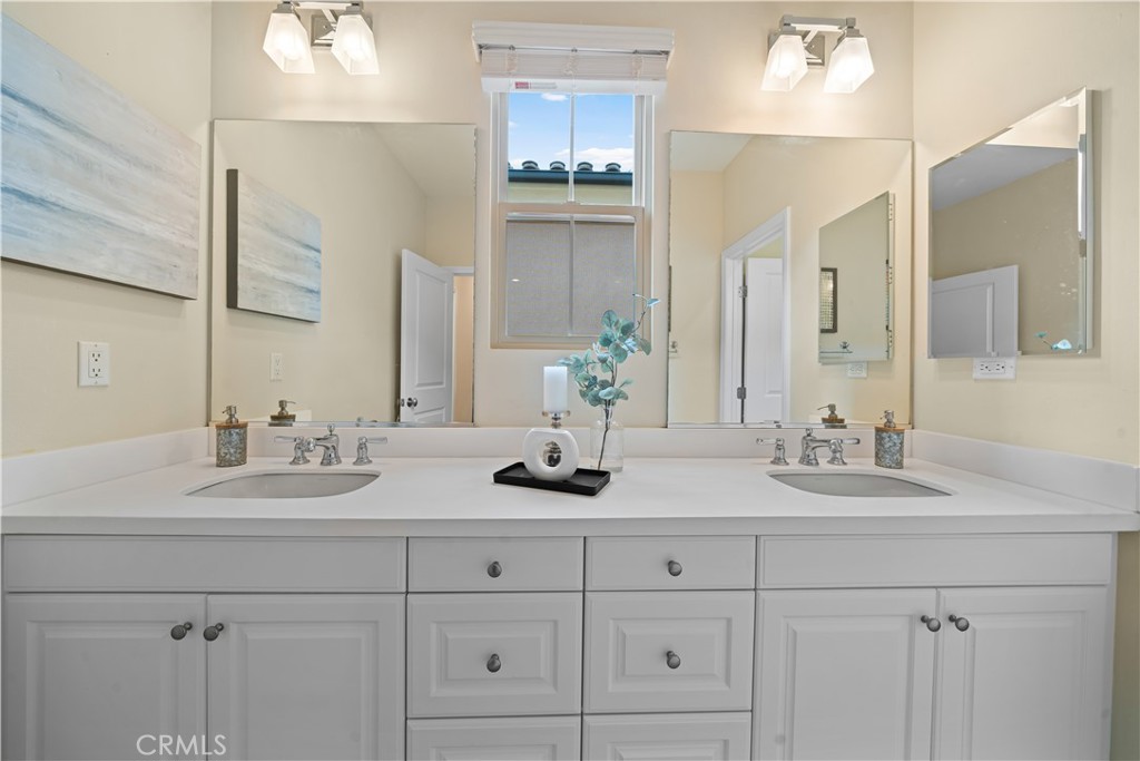 58 Elmdale Irvine, CA 92620 - Photo 4 of 5 a bathroom with double sink and a mirror