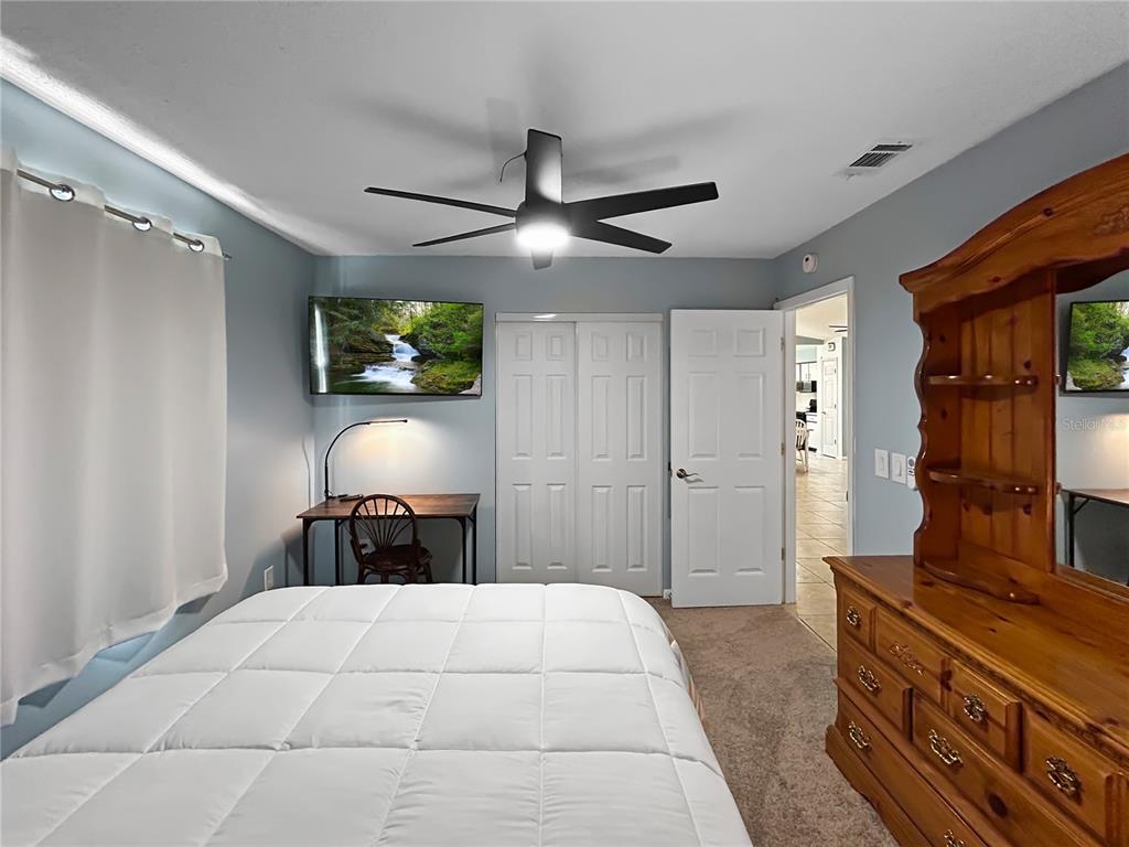 136 Paul Revere Road Bartow, FL 33830 - Photo 13 of 17 a bedroom with a bed and a flat tv screen on dresser