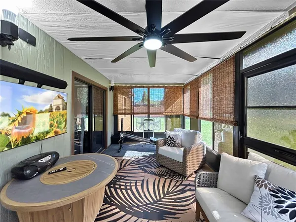 a dining room with furniture and a large window