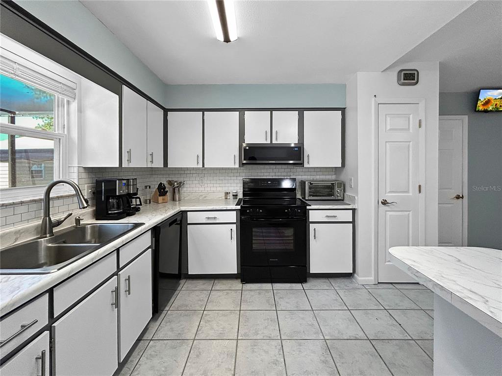 136 Paul Revere Road Bartow, FL 33830 - Photo 7 of 17 a kitchen with a sink appliances and cabinets