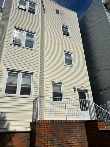 a view of a house with wooden deck
